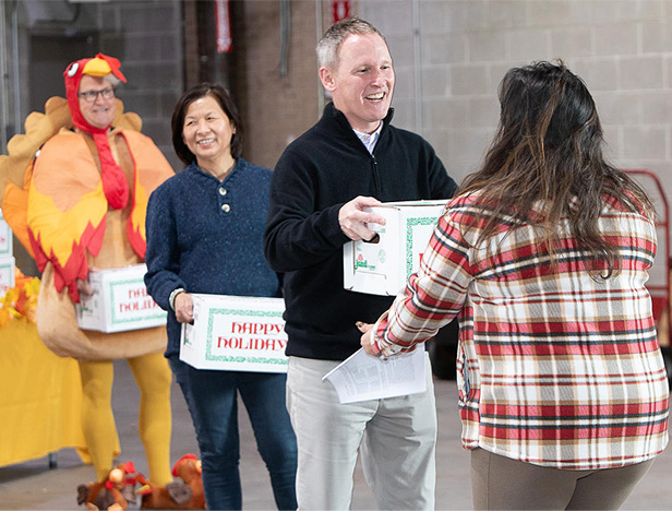 ASI company leaders distribute turkeys